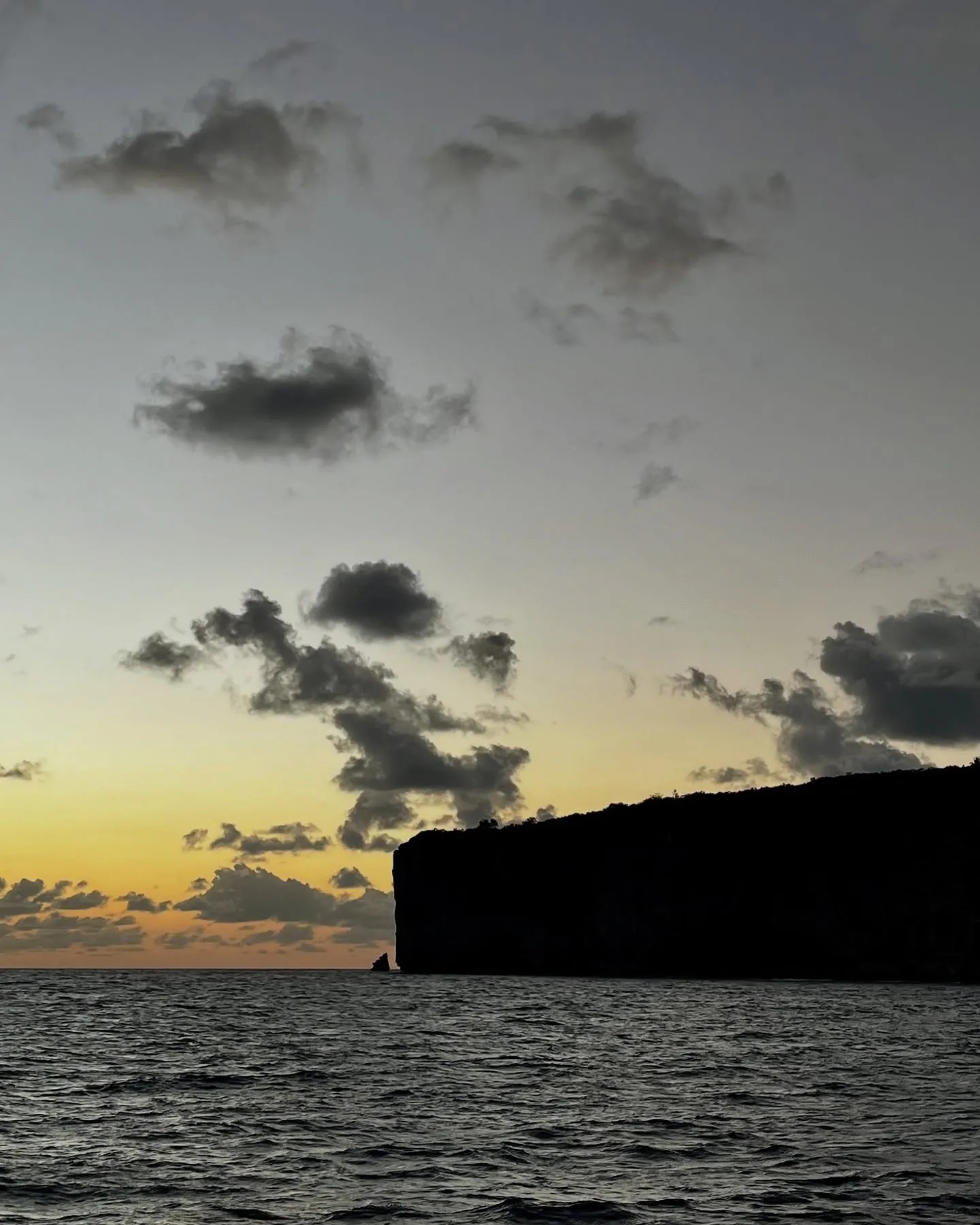 Limestone cliffs in silhouette at sunset. Limestone cliffs in silhouette at sunset.