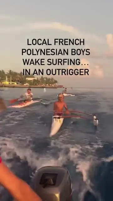 An outrigger canoe catching a free ride on our wake. An outrigger canoe catching a free ride on our wake.