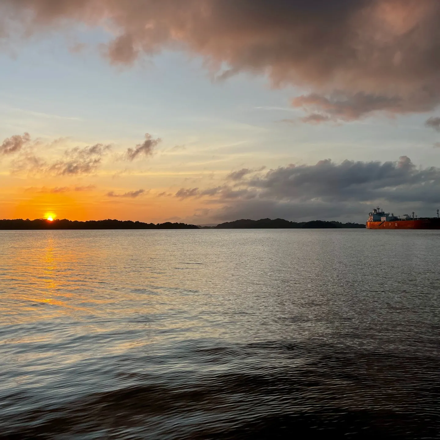 Sunset over the water, with a ship for company. Sunset over the water, with a ship for company.