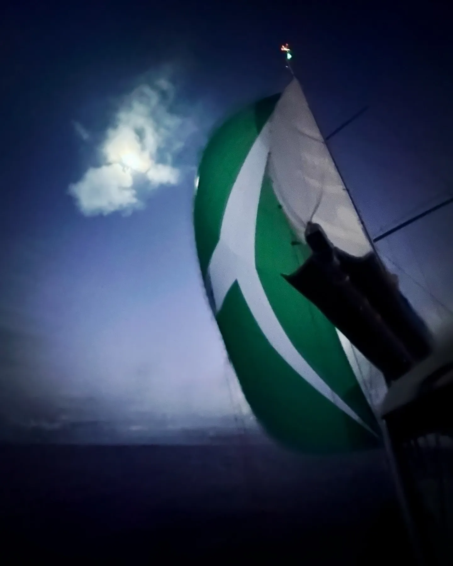 Flying the spinnaker at night.
