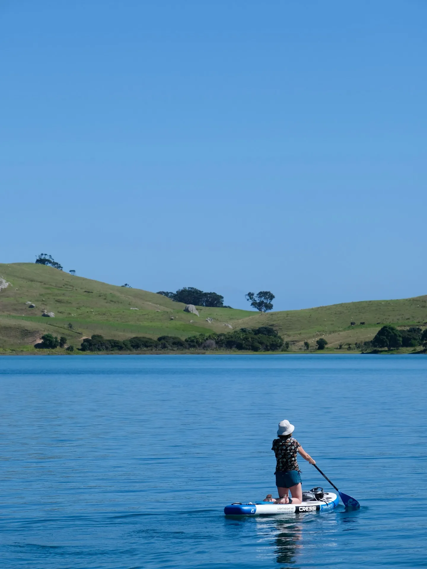 Paddleboarding on glassy water. Paddleboarding on glassy water.