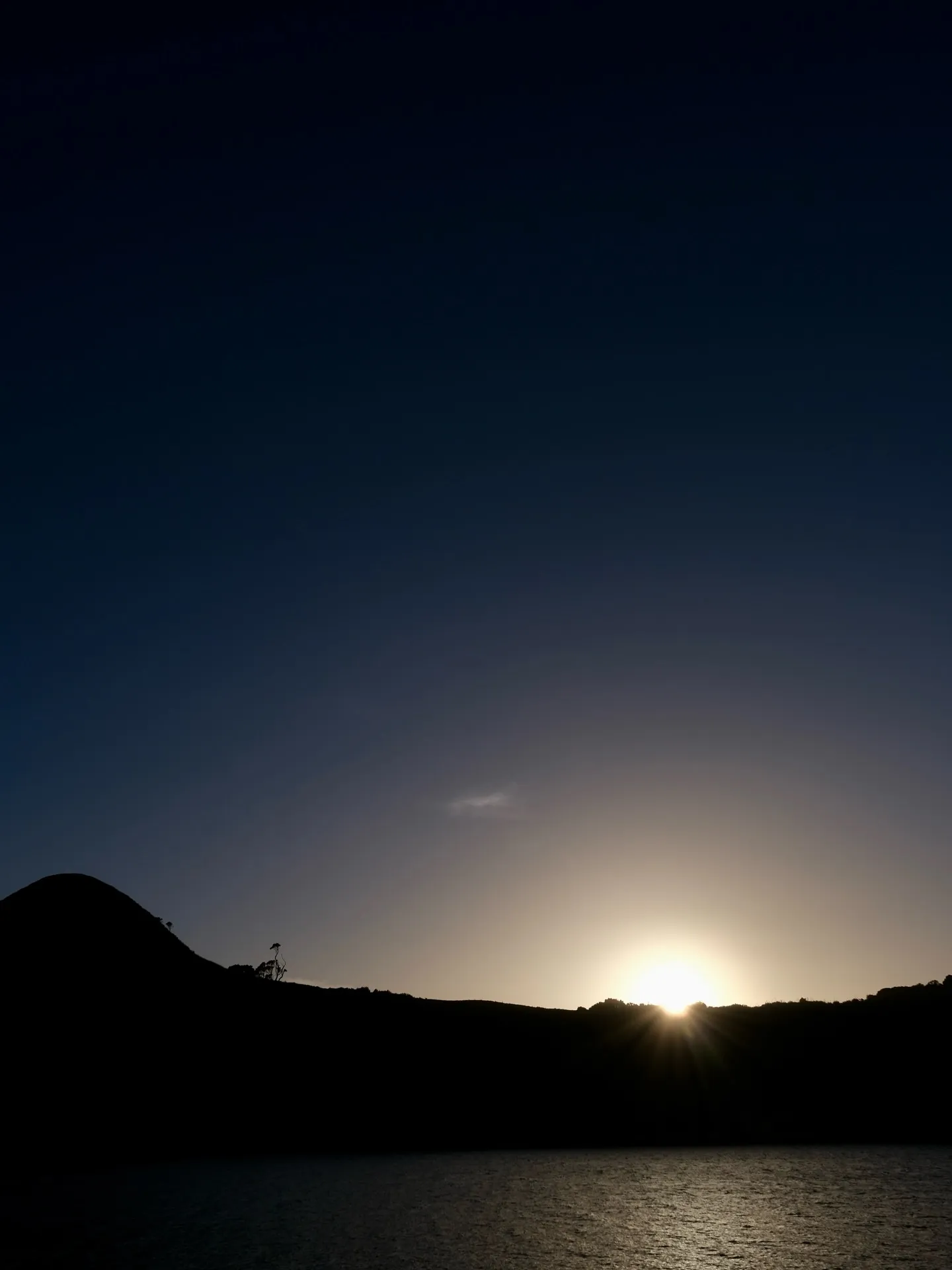 The sun dipping behind the hills. The sun dipping behind the hills.