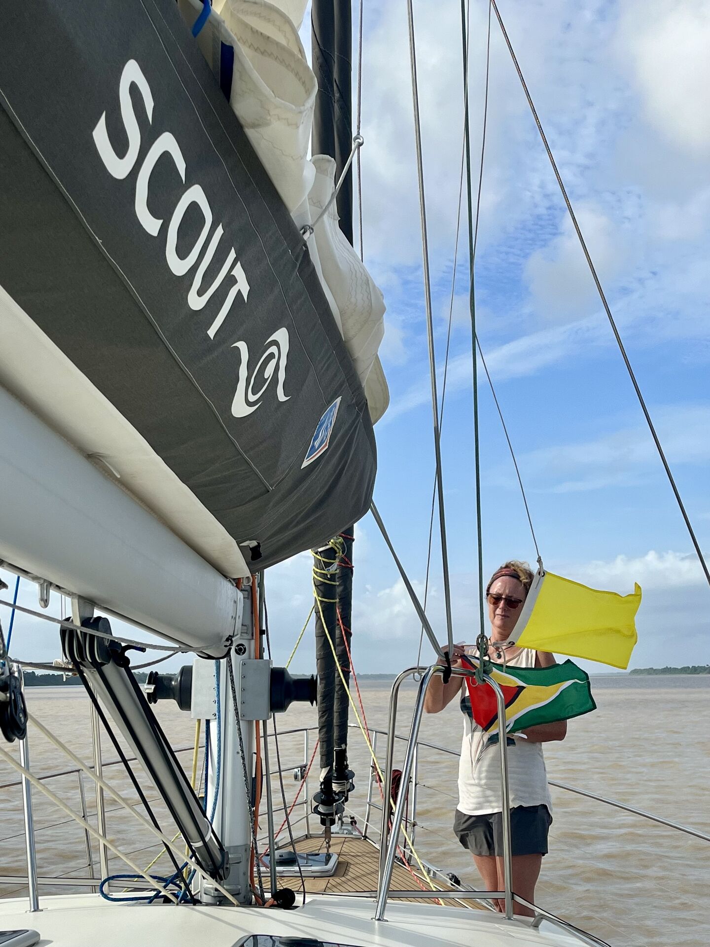 Raising the Guyanese courtesy flag at the mouth of the Essequibo river, Guyana.