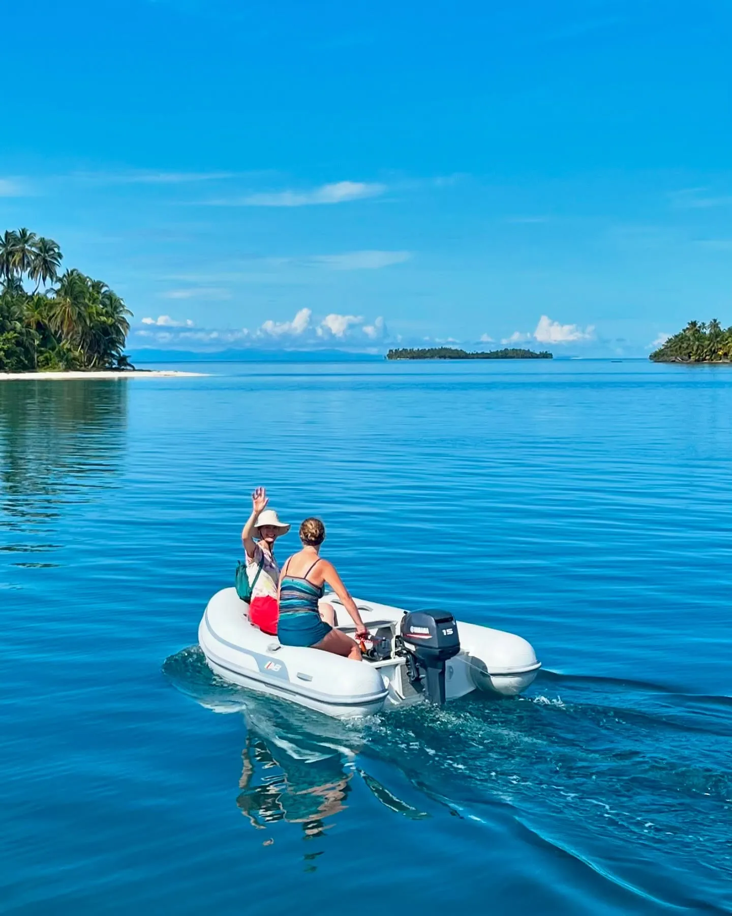 Heading ashore by dinghy on a glassy day. Heading ashore by dinghy on a glassy day.