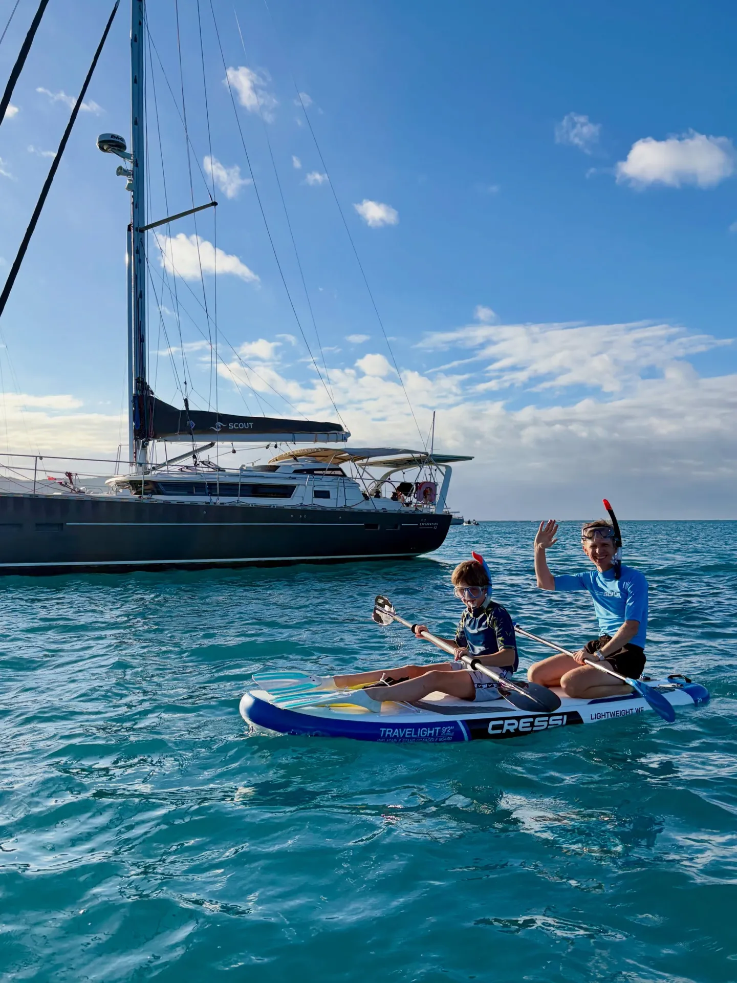 Family guests paddle boarding beside Scout. Family guests paddle boarding beside Scout.