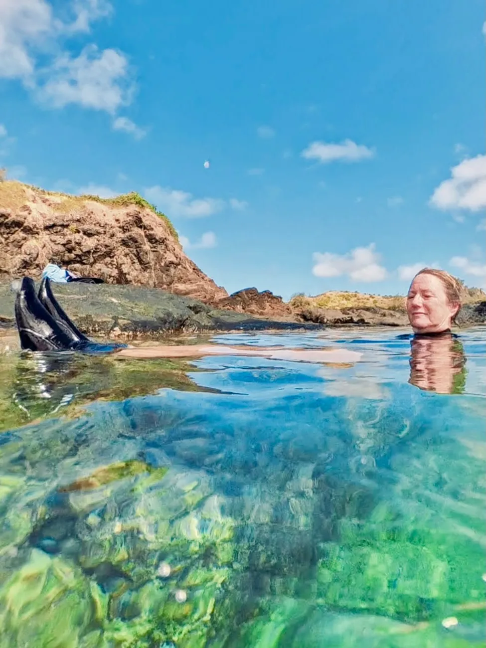 Floating in a crystal-clear rock pool. Floating in a crystal-clear rock pool.